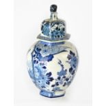 A late 19th/early 20th century Dutch Delft blue and white cylindrical vase with cover,