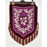 A Victorian beadwork in the form of a shield with tassels and fringes,