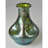 A Loetz style silver overlaid glass vase of bottle form with green lustre pinched body,