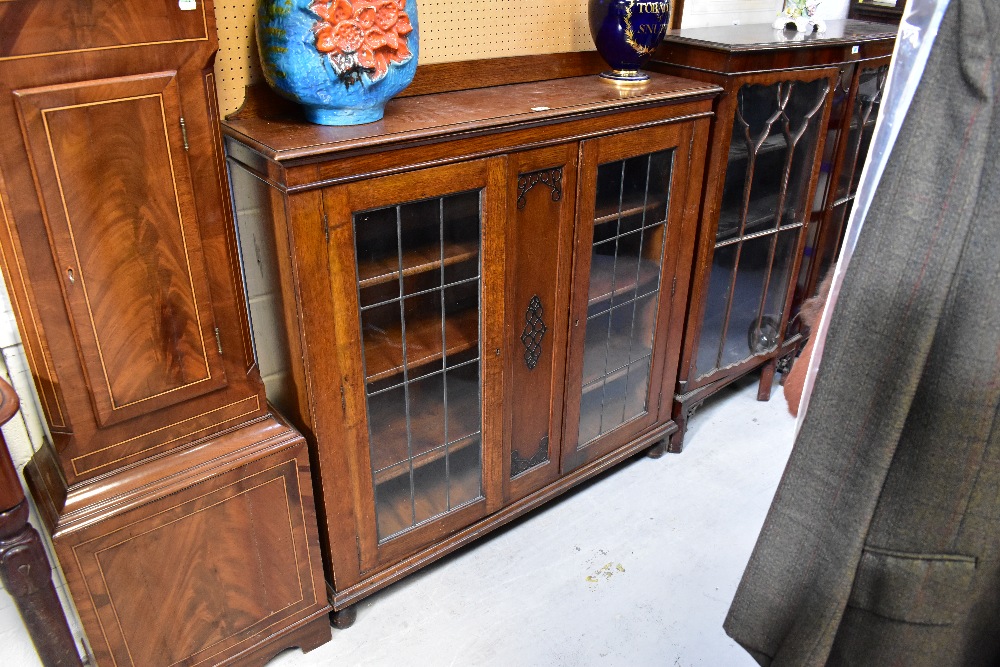 An early 20th century oak two-door display cabinet,