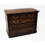 An early 20th century stained pine chest of four long drawers, to plinth base, raised on castors,