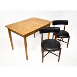 A 1960s vintage teak dining suite with crossbanded rounded rectangular extending table raised on