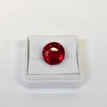 A loose 9.72 carat round ruby with GIL Laboratory Certificate.