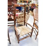 A late 18th/early 19th century rush seated low chair with high back,