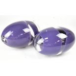 Two decorative glass ovoids in the style of Murano, with purple band decoration,