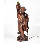 A late 19th/early 20th century root wood figure of a man walking barefoot,