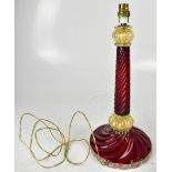 A cranberry and gilt wrythen twist glass table lamp, with spreading circular foot, height 43cm.