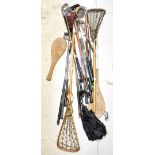 A collection of vintage and contemporary golf clubs, some with wooden handles to include H.H.