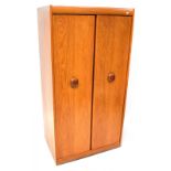 A retro 1970s teak two-door wardrobe.