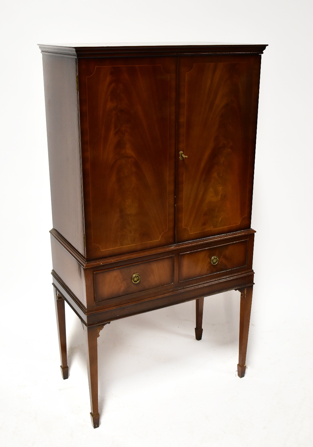 A reproduction mahogany-style cocktail cabinet, the interior with mirrored back,