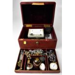A vintage red leather jewellery box and contents,
