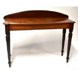 A 19th century mahogany console table with arched back, shaped top,