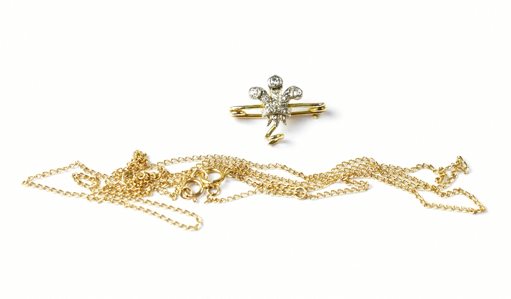 A Fleur De Lys brooch set with diamonds and a fine link chain necklace, clasp marked 375 (2).