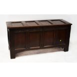 An 18th century large oak panelled front and top mule chest with peg joints and modern steel hinges,