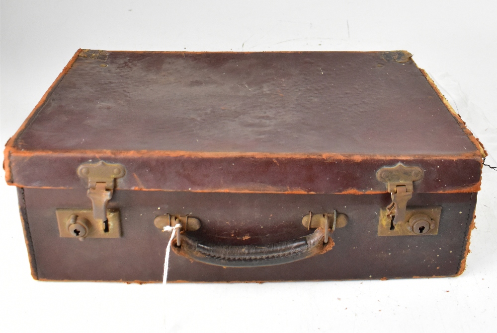 A small vintage brown suitcase containing a quantity of Victorian,