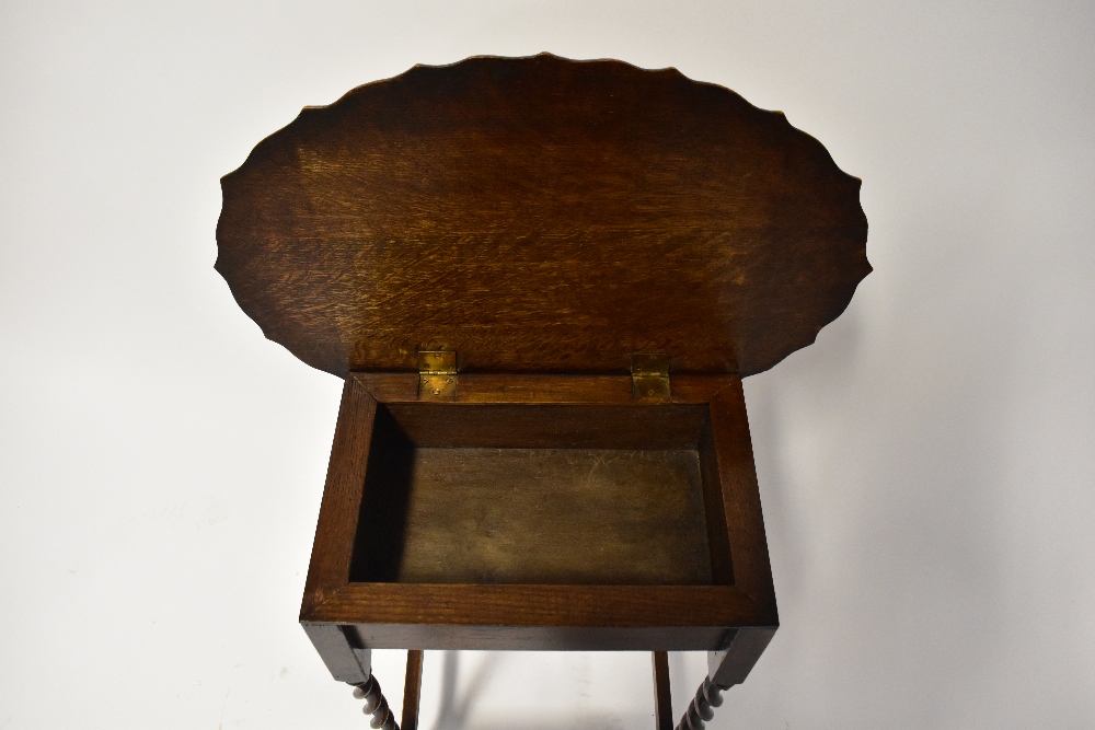 A reproduction oak sewing table, the shaped oval hinged lid opening to reveal a box section, - Image 3 of 3