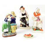 A group of 19th century and later pottery figures to include a pair of Staffordshire figures of a