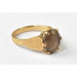 A vintage 1970s 9ct gold dress ring, with claw set transparent brown stone,