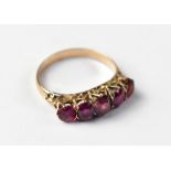 A yellow metal five-stone ruby ring,