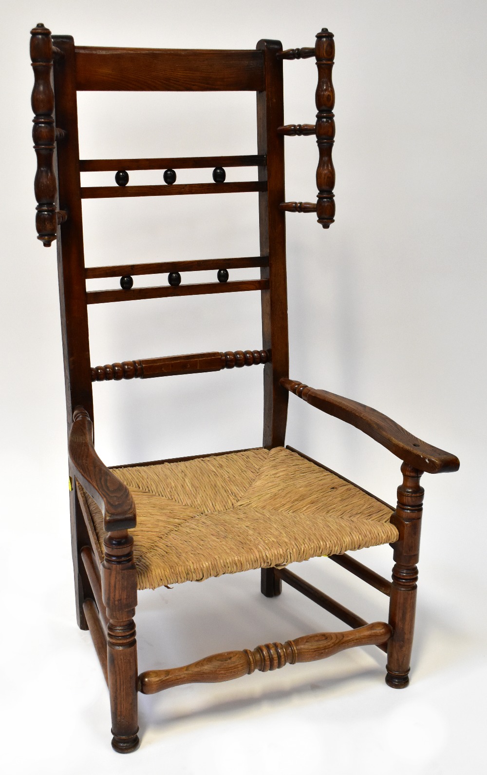 A late 18th/early 19th century rush seated low chair with high back,