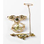 Three late 19th/early 20th century gold brooches, one with three blue stone flower centre,