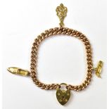 A 9ct yellow gold charm bracelet with three gold charms comprising a shoe,