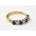 An 18ct yellow gold diamond and green tourmaline half eternity ring,