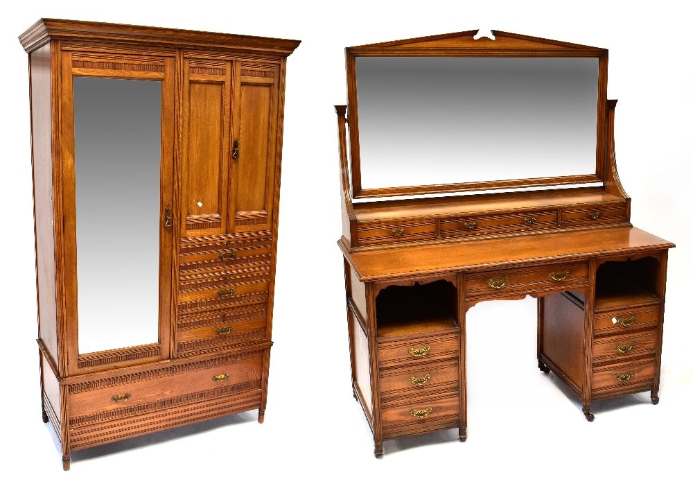 An Edwardian two-piece oak bedroom suite comprising a double wardrobe,