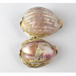 Two engraved cowrie shells, one 'P. Del Mare' with figures in a sailing boat, width 7.