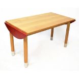 A modern stylised bespoke made oak table with an extending D-shaped small flap either end,