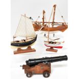 Three modern models of boats, the smallest numbered 'VI-5-233' and named 'Juaneta',