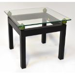 A modern stylised glass top bedside/coffee table,