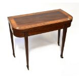 An Edwardian cross banded mahogany and kingwood fold-over gateleg card table with simple frieze,