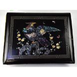 An early 20th century black lacquered postcard album decorated with mother of pearl inlaid birds to