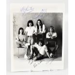 STATUS QUO; a black and white photograph of the band bearing all five signatures, 25 x 20.5cm.