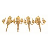 A set of eight gilt wood two-branch wall sconces with scrolling acanthus leaf decoration,