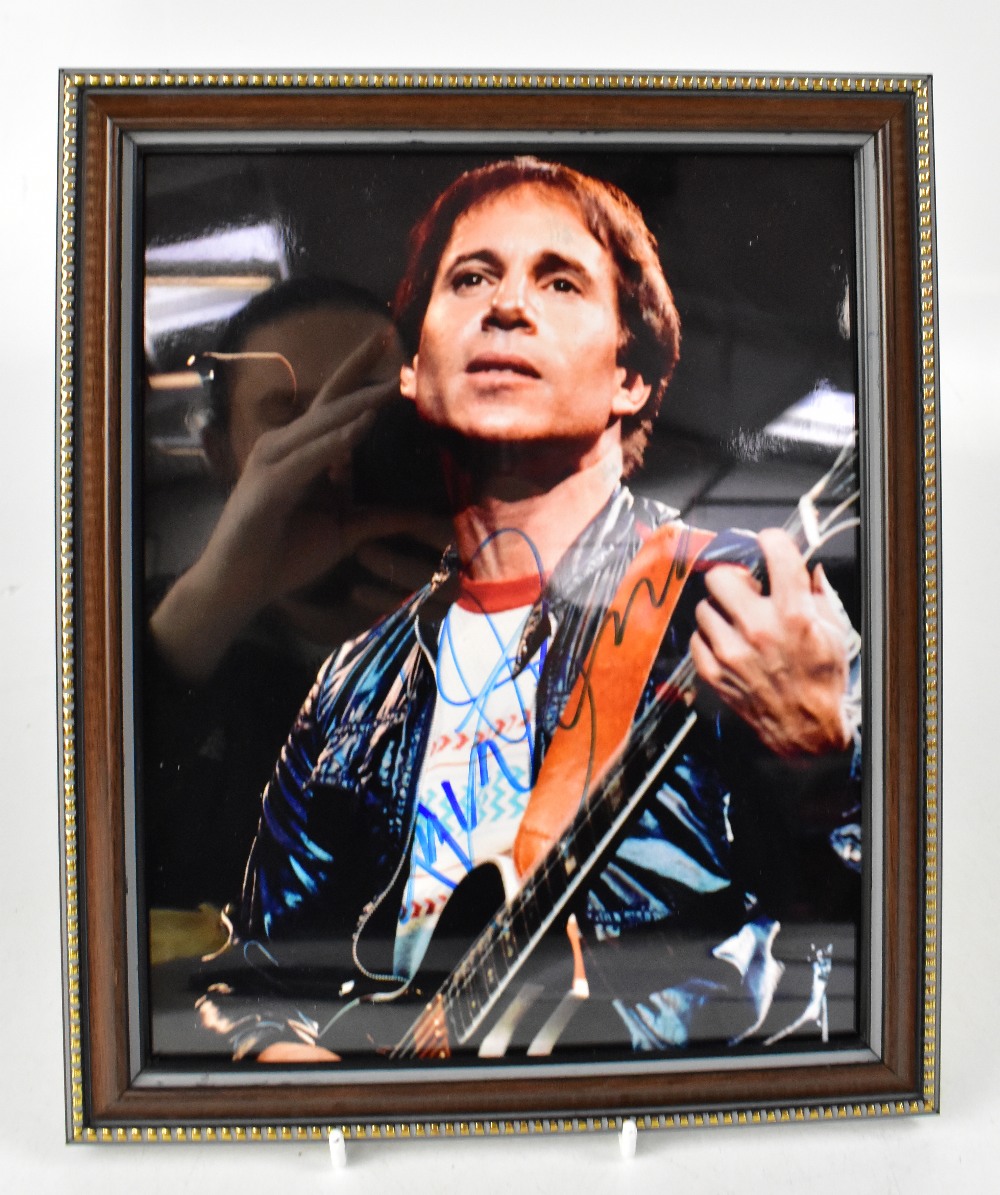 ROCK & POP; a group of nine autographed stock photographs of music stars to include Paul Simon,