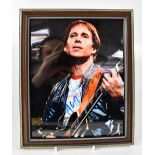 ROCK & POP; a group of nine autographed stock photographs of music stars to include Paul Simon,