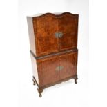 A mid-20th century crossbanded burr walnut veneered double dome topped cocktail cabinet,