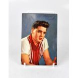 ELVIS PRESLEY; a coloured postcard of the rock and roll icon bearing his signature to the front,