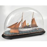 An early 20th century diorama of a small sailing ship with wooden sails,