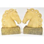 A pair of alabaster/reconstituted marble horse head bookends on square marble bases,