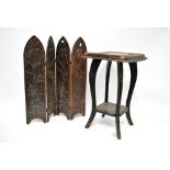 An Arts and Crafts carved wooden four-leaf folding screen with tulip and flower head decoration,