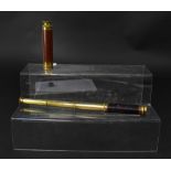 A small brass three-drawer telescope, with wooden sheath to the outer sleeve,