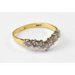 A 9ct yellow gold diamond wishbone ring, with seven claw set tiny brilliant cut diamonds,