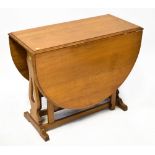 A good quality oak reproduction gateleg table of oval shape,