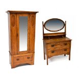 An early 20th century oak two-piece bedroom suite comprising a wardrobe with single mirrored door