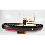 A scratch-built model steamship with black hull and varnished decks,