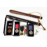 Police memorabilia and commemorative ware comprising two mid-20th century turned wooden truncheons,