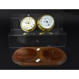 A Nauticalia clock and barometer on a stained oak oval wall-hanging mount and a white marble